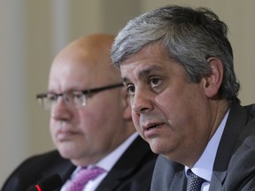 German Finance Minister Peter Altmaier, left, and his Portuguese counterpart and President of the euro group Mario Centeno, right, brief the media after a meeting at the Finance Ministry in Berlin, Wednesday, Jan. 17, 2018.