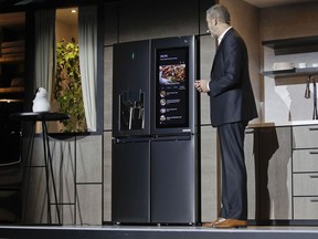 LG's David Vander Waal introduces the InstaView ThinQ smart refrigerator during a news conference at CES International, Monday, Jan. 8, 2018, in Las Vegas.