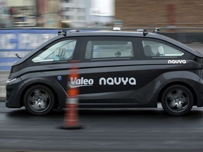 A Navya Autonom Cab, a self-driving vehicle, drives down a street during a demonstration at CES International, Monday, Jan. 8, 2018, in Las Vegas.