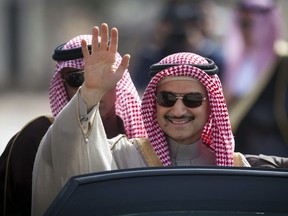 FILE - In this Feb. 4, 2014 file photo, Saudi billionaire Prince Alwaleed bin Talal, waves as he arrives at the headquarters of Palestinian President Mahmoud Abbas in the West Bank city of Ramallah. Alwaleed bin Talal was released on Saturday, Jan. 27, 2018,  from the luxury hotel where he has been held since November, according to three of his associates, marking the end of a chapter in a wide-reaching anti-corruption probe that has been shrouded in secrecy and intrigue. The prince, 62, had been the most well-known and prominent detainee held at the Ritz-Carlton hotel in the Saudi capital, Riyadh, since Nov. 4, when his much younger cousin, Crown Prince Mohammed bin Salman, ordered the surprise raids against prominent princes, businessmen, ministers and military officers.