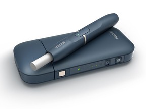 This undated image provided by Philip Morris in January 2018 shows the company's iQOS product. The device heats tobacco sticks but stops short of burning them, an approach that Philip Morris says reduces exposure to tar and other toxic byproducts of burning cigarettes. This is different from e-cigarettes, which don't use tobacco at all but instead vaporize liquid usually containing nicotine. (Philip Morris via AP)