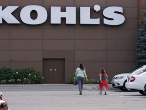 FILE - In this Aug. 22, 2017, file photo, shoppers walk to a Kohl's retail store in Salem, N.H. Kohl's said its holiday sales surged 6.9 percent from the prior-year period, another sign that the retail industry experienced healthy growth during the critical shopping season. The company also boosted its full-year earnings forecast, citing the better-than-expected performance.