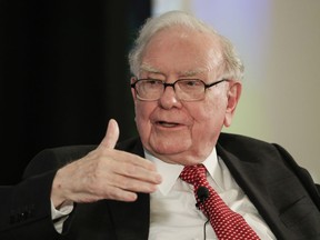 FILE - In this Oct. 3, 2017, file photo, investor Warren Buffett gestures on stage during a conversation with CNBC's Becky Quick, at a national conference sponsored by the Purpose Built Communities group that Buffett supports, in Omaha, Neb. Buffett's Berkshire Hathaway is adding Gregory E. Abel and Ajit Jain as directors, boosting the size of its board to 14 members. The company said Wednesday, Jan. 10, 2018, that Buffett and Charles T. Munger, Berkshire Hathaway's vice chairman, will retain their positions on the board.