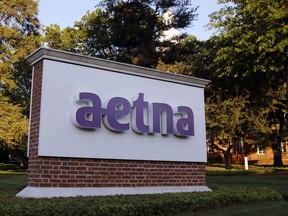 FILE - This Thursday, June 1, 2017, file photo shows a sign on the campus of the Aetna headquarters in Hartford, Conn. Aetna Inc. reports earnings Tuesday, Jan. 30, 2018.