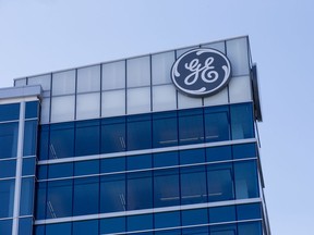 In this Tuesday, Jan. 16, 2018, photo, the General Electric logo is displayed at the top of their Global Operations Center in the Banks development of downtown Cincinnati. General Electric Co. reports earnings, Wednesday, Jan. 24, 2018.
