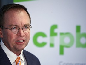 FILE - In this Monday, Nov. 27, 2017, file photo, Mick Mulvaney speaks during a news conference after his first day as acting director of the Consumer Financial Protection Bureau in Washington. Mulvaney said Wednesday, Jan. 17, 2018, that he is launching a review of all the federal consumer watchdog agency's policies and priorities.