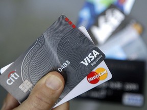 FILE - In this June 15, 2017, file photo, credit cards are displayed in Haverhill, Mass. If you have excellent credit, you can use your credit rating to your financial advantage without borrowing money. Oddly, exploiting your great credit rating often improves it.