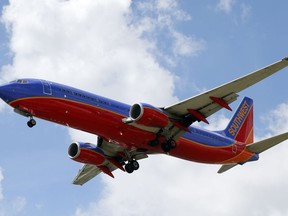FILE - In this Aug. 26, 2016, file photo, a Southwest Airlines jet makes its approach to Dallas Love Field airport, in Dallas. Southwest Airlines Co. reports earnings, Thursday, Jan. 25, 2018.