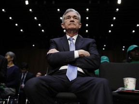 FILE- In this Nov. 28, 2017, file photo, Jerome Powell, President Donald Trump's nominee for chairman of the Federal Reserve, sits in the audience before being called to testify during a Senate Banking, Housing, and Urban Affairs Committee confirmation hearing on Capitol Hill in Washington. The Senate on Tuesday, Jan. 23, 2018, approved Powell to be the next chairman of the Federal Reserve beginning next month.