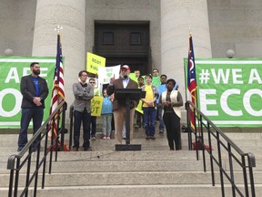 FILE – In this May 9, 2017, file photo, Bill Lager, center, co-founder of Ohio's largest online charter school, the Electronic Classroom of Tomorrow or ECOT, speaks to hundreds of supporters during a rally outside the Statehouse in Columbus, Ohio. The virtual school could lose its required sponsor and abruptly close in early 2018, although ECOT has said it's working to remain open. Wednesday, Jan. 17, 2018, is the school's deadline to send a proposed remedy to the sponsor, Educational Service Center of Lake Erie West.