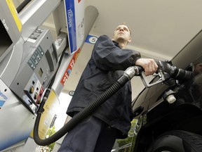 FILE- In this May 6, 2015 file photo, attendant James Lewis pumps gas at a station in Portland, Ore. An Oregon law passed nearly seven decades ago banned drivers from pumping their own gas but now that's changing, in some cases. The new year ushered in some modifications to the aging law that makes Oregon only one of two states in the U.S. that places restrictions on self-service gas.