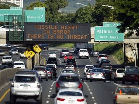 FILE - In this Jan. 13, 2018, file photo provided by Civil Beat, cars drive past a highway sign that says "MISSILE ALERT ERROR THERE IS NO THREAT" on the H-1 Freeway in Honolulu. A Hawaii employee who mistakenly sent an alert warning of an incoming ballistic missile earlier this month, creating a panic across the state, thought an actual attack was imminent, the Federal Communications Commission said Tuesday, Jan. 30, 2018.