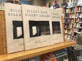 FILE - In this Oct. 31, 2017, file photo, copies of Allen Say's "Silent Days, Silent Dreams" sit on a bookshelf at a store in Boise, Idaho. The Boise, Idaho,-based James Castle Collection and Archive in a document filed Tuesday, Jan. 16, 2018, in U.S. District Court says Allen Say's "Silent Days, Silent Dreams" steals images created by Castle and its lawsuit should be allowed to proceed.