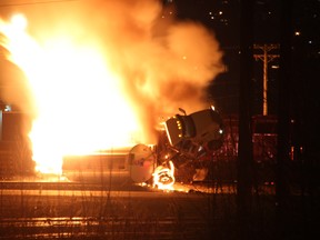 Fire rises from a tanker truck carrying ethanol gas after hitting a CP Rail car in Port Coquitlam, B.C. on Monday Jan. 22, 2018. Firefighters were still on the scene of a large fire in Port Coquitlam, B.C., late Monday after a collision in a CP Rail yard. The city says the blaze began when a tanker truck carrying ethanol gas hit a CP Rail car at about 7 p.m. THE CANADAIN PRESS/Shane MacKichan ORG XMIT: VCRX301