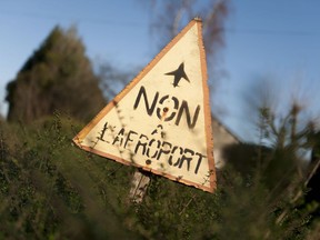 A sign reading "No to the airport" is pictured in the "ZAD" (zone to defend) in Notre-Dame-des-Landes, outside the city of Nantes, western France, Wednesday, Jan. 17, 2018. Prime Minister Edouard Philippe says that the government has decided against building an airport in western France that has mobilized nearly a decade of sometimes violent protests and he told protesters occupying the site that they must leave.