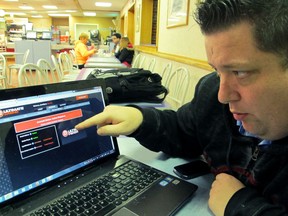 In this Nov. 21, 2013, photo, Joseph Brennen tries to log on to a gambling site while at a highway rest stop in Egg Harbor Township N.J., on the first night of New Jersey's Internet gambling test. On Thursday, Jan. 11, 2018, New Jersey lawmakers from both political parties urged the U.S. Justice Department to keep internet gambling legal, responding to a request from two U.S. senators to reverse a 2011 ruling that internet gambling does not violate federal law.