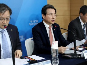 South Korea's Financial Services Commission Vice Chair Kim Yong-beom, center, speaks at the government complex in Seoul, South Korea, Tuesday, Jan. 23, 2018. South Korea said Tuesday that local banks will launch a real-name system for crypto currency trading that make anonymous transactions to be traceable as the country seeks to curb speculation and criminal activities.