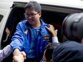 FILE - In this Dec. 27, 2017, file photo, Reuters journalist Thet Oo Maung, known as Wa Lone, exits a police van as he arrives for a court appearance, outside Yangon, Myanmar. Myanmar is set to put two reporters from the Reuters news agency on trial after they were charged under a colonial-era state secrets act, in a case that highlights growing concerns about press freedom in the country.
