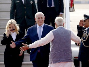 Israel's Prime Minister Benjamin Netanyahu, center, and his wife Sarah, left, are greeted by India's Prime Minister Narendra Modi on their arrival at Palam airport in New Delhi Sunday, Jan. 14, 2018.  Israeli Prime Minister Netanyahu arrived Sunday for his first visit to India to expand defense, trade and energy ties. (AP Photo)