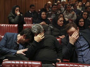 Friends and colleagues of the deceased Iranian seafarers aboard a tanker that sank off the coast of China weep at the headquarters of National Iranian Tanker Company, in Tehran, Iran, Sunday, Jan. 14, 2018. The burning Iranian tanker listing for days off the coast of China after a collision with another vessel sank Sunday, with an Iranian official saying there was "no hope" of survival for the 29 missing sailors onboard.