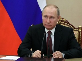 In this Jan. 26, 2018, photo, Russian President Vladimir Putin chairs a Security Council meeting in Moscow, Russia. The State Department has notified Congress that it will not impose new sanctions on Russia at this time. The State Department says it is confident that new legislation enacted last year is significantly deterring Russian defense sales.