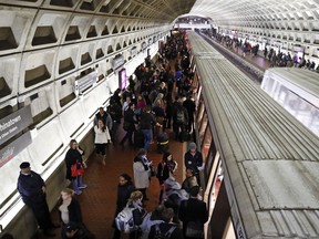 In this Jan. 11, 2018, photo, riders wait to board as others depart a Metro train in the Gallery Place-Chinatown Metro Station in Washington. Washington's Metro system has become internationally synonymous with delays, breakdowns and smoke-filled tunnels.