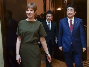 Japanese Prime Minister Shinzo Abe, right, and Estonian President Kersti Kaljulaid, left, arrive for their talks in Tallinn, Estonia, Friday, Jan. 12, 2018. Abe is on a visit to three Baltic countries, Estonia, Latvia and Lithuania.