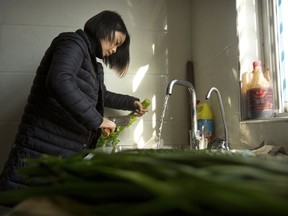 In this Dec. 17, 2017, photo, Deng Guilian, the wife of Chinese labor activist Hua Haifeng, chops vegetables in the kitchen in her home on the outskirts of Xiangyang in central China's Hubei Province. Deng Guilian wasn't planning on going back to work - until her husband was arrested while investigating Ivanka Trump's Chinese suppliers. She took a job at a local karaoke parlor and sleeps in a workplace dorm. Now she gets three days off a month to see her two young children.