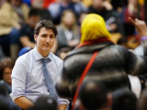 Prime Minister Justin Trudeau listens to a question about Child and Family Services at a town hall meeting at the University of Manitoba in Winnipeg, Wednesday, January 31, 2018.