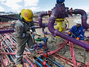 Workers tend to a well head during a hydraulic fracturing operation in Colorado. Crilling has been so intense near Fox Creek, Alberta that it’s been linked to a series of earthquakes.