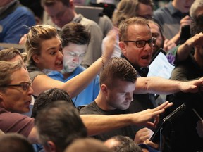 Traders signal offers in the S&P options pit at the Cboe Global Markets exchange on Feb. 6 in Chicago.