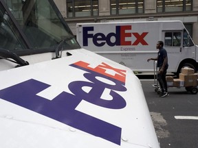 In this Tuesday, Aug. 22, 2017, photo, FedEx trucks are parked in New York. Shares of delivery companies FedEx and UPS are falling in Friday, Feb. 9, 2018, premarket trading following a report that powerhouse Amazon is readying its own delivery service for businesses.
