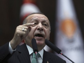 Turkey's President and leader of ruling Justice and Development Party Recep Tayyip Erdogan addresses the members of his ruling party at the parliament in Ankara, Turkey, Tuesday, Feb. 13, 2018. Erdogan issued a warning Tuesday to Greece, Cyprus and international companies exploring for gas in the eastern Mediterranean not to "step out of line" and encroach on Turkey's rights.
