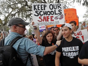FILE - In this Wednesday, Feb. 21, 2018 file photo, student survivors from Marjory Stoneman Douglas High School are greeted as they arrive at a rally for gun control reform on the steps of the state capitol, in Tallahassee, Fla. Dozens of college and universities are telling students who may face discipline at their high schools for participating in gun control demonstrations to relax: It won't affect their chances of getting into their schools. Nearly 50 schools including Yale, Dartmouth and UCLA have taken to social media to reassure the students.