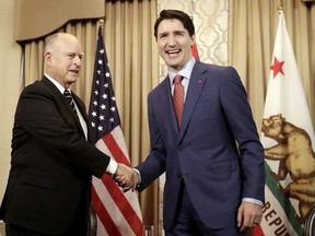 Canada's Prime Minister Justin Trudeau, right, shakes hands with California Gov. Jerry Brown during a meeting in San Francisco, Friday, Feb. 9, 2018.