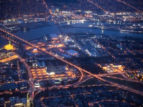 City lights are seen illuminated at night in this aerial photograph taken over Vancouver, British Columbia, Canada.
