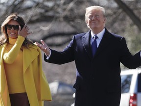 President Donald Trump and first lady Melania Trump pause as they walk to Marine One across the South Lawn of the White House in Washington, Monday, Feb. 5, 2018, for the short trip to Andrews Air Force Base en route to Ohio.