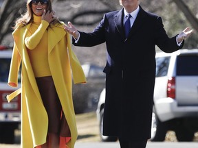 President Donald Trump and first lady Melania Trump pause as they walk to Marine One across the South Lawn of the White House in Washington, Monday, Feb. 5, 2018, for the short trip to Andrews Air Force Base en route to Ohio.