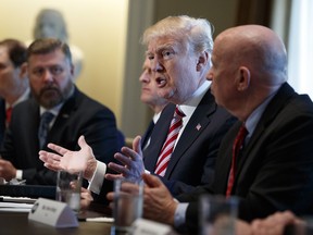 President Donald Trump speaks during a meeting with lawmakers about trade policy in the Cabinet Room of the White House, Tuesday, Feb. 13, 2018, in Washington. From left, Sen. Ron Wyden, R-Ore., Rep. Rick Crawford, R-Ariz., Sen. Pat Toomey, R-Pa., Trump, and Rep. Kevin Brady, R-Texas.