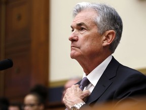 Federal Reserve Chairman Jerome Powell straightens his tie before testifying before the House Financial Services Committee, Tuesday, Feb. 27, 2018, in Washington.
