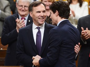 Finance Minister Bill Morneau is congratulated by Prime Minister Justin Trudeau after delivering the federal budget on Feb. 27.