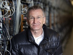 In this photo taken on Jan. 17, 2018, Helmut Rauth, the director of Genesis Mining poses for a portrait next to a row of computer rigs that run around the clock 'mining' bitcoin in Keflavik, Iceland. Hand in hand with the rise of bitcoin is a soaring cost of "mining" the cryptocurrency. The energy demand has developed because of the soaring cost of producing the cryptocurrency, which requires computers solving math formulas to mine the 4.2 million coins still available.