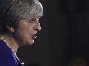 Britain's Prime Minister Theresa May speaking in Manchester, England Tuesday Feb. 6, 2018 to mark the 100th anniversary of a British law giving some female voters the right to go to the polls.  The 100th anniversary of the Representation of the People Act, which extended voting rights to all British men aged 21 and up, and to millions of women over 30. British women did not get the same voting rights as men until 1928.