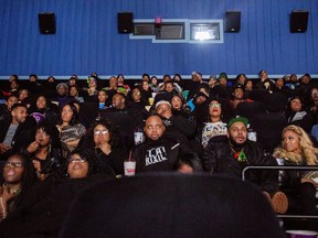 Audience members watch the beginning of "Black Panther" during a private screening on Friday, Feb. 16, 2018, in Grand Blanc, Mich.