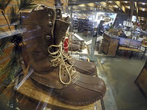 FILE - In this March 17, 2017 file photo, a early version of the Maine Hunting Shoe is displayed at the L.L. Bean flagship store in Freeport, Maine. L.L. Bean is tightening its generous return policy by imposing a one-year limit on most returns to reduce abuse and fraud. Executives say returns of severely worn items have doubled over five years. Under the new policy announced Friday, Feb. 9, 2018, the company will accept returns for one year with a proof of purchase and will continue to replace products for manufacturing defects beyond that.