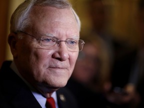 FILE - In this Jan. 11, 2018 file photo, Georgia Gov. Nathan Deal talks to reporters after delivering the State of the State address at the state Capitol in Atlanta. With Atlanta among the 20 cities still being considered for Amazon's second headquarters, lawmakers and lobbyists are citing the corporate giant in various legislative battles. Two flashpoints have been a "religious liberties" bill _ viewed by some as anti-LGBT _ as well as a trio of bills dubbed by opponents as "adios Amazon" because they're related to immigration issues.