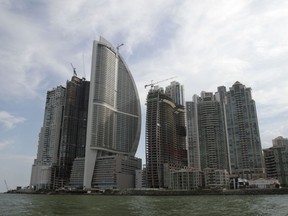 FILE - This July 4, 2011, file photo, shows the Trump International Hotel Panama , third building from left, in Panama City.  One of President Donald Trump's family businesses is battling an effort to physically evict its team of executives from the luxury hotel where they manage operations, and local police have been called repeatedly to keep peace, The Associated Press has learned.   Representatives of the hotel owners' association formally sought to fire Trump's management team Thursday, Feb. 22, 2018, by hand-delivering termination notices to them at the Trump International Hotel and Tower, according to a Panamanian legal complaint filed by Orestes Fintiklis, who controls 202 of the property's 369 hotel units.
