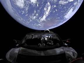 This image from video provided by SpaceX shows the company's spacesuit in Elon Musk's red Tesla sports car which was launched into space during the first test flight of the Falcon Heavy rocket on Tuesday, Feb. 6, 2018. (SpaceX via AP)