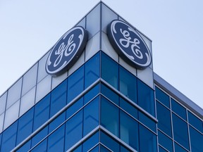 FILE - In a Tuesday, Jan. 16, 2018 file photo, the General Electric logo is displayed at the top of their Global Operations Center, in the Banks development of downtown Cincinnati. Days after revealing that it must restate two years of earnings, General Electric Co. is reshaping its board of directors. After cutting the size of its board from 18 to 12, General Electric Co. said Monday, Feb. 26, 2018 that a quarter of that board would consist of new members, including Danaher Corp. CEO Lawrence Culp, American Airlines CEO Thomas Horton and Leslie Seidman, former chairman of the Financial Accounting Standards Board.
