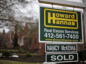 FILE- This Jan. 22, 2018, file photo shows a sale sign in front of a home in Mount Lebanon, Pa. Economists project that sales of previously occupied homes edged higher in January from a month earlier. The National Association of Realtors is expected to report Wednesday, Feb. 21, that sales rose to a seasonally adjusted annual rate of 5.60 million last month.